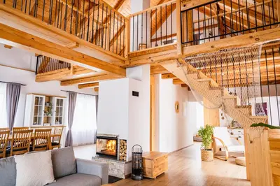 a living room with a staircase and a fireplace at Pri stari mami in Tomaž pri Ormožu