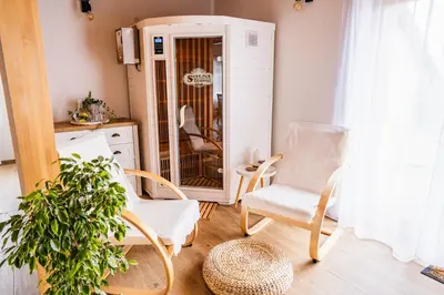 a living room with two chairs and a mirror at Pri stari mami in Tomaž pri Ormožu