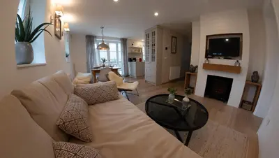 a living room with a couch and a fireplace at Creek House Bohinj in Bohinj