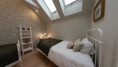 a bedroom with a bed and a skylight at Creek House Bohinj in Bohinj