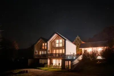 a house at night with the lights on at Green Valley Apartments in Zavrč