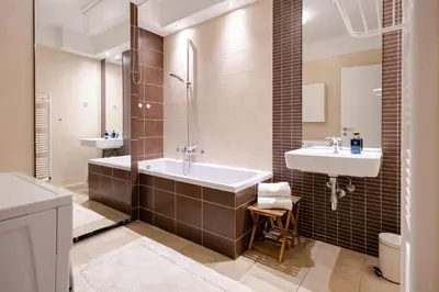 a bathroom with a tub and a sink at Waterfall Apartment - Cozy Mountain Retreat in Kranjska Gora