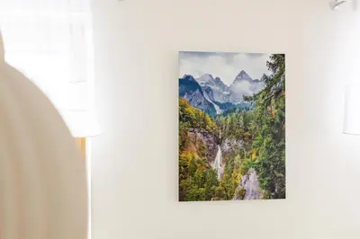 a picture of a waterfall in the mountains at Waterfall Apartment - Cozy Mountain Retreat in Kranjska Gora