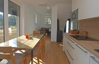 a kitchen and dining room with a table and chairs at Hiša Štolc in Gornja Radgona