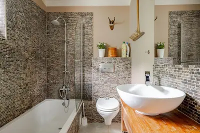 a bathroom with a tub and a sink and a toilet at Bela Luna - Charming Garden Cottage near Lake Bled in Bohinjska Bela