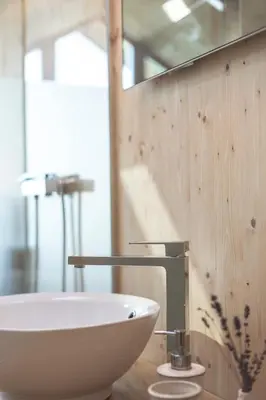 a bathroom with a white sink and a mirror at Glamping house Julija - Wellness & View in Ivanjkovci