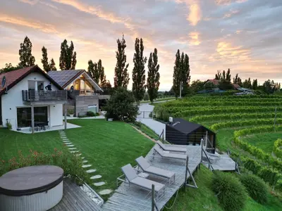 a backyard with chairs and a table and a house at Glamping house Julija - Wellness & View in Ivanjkovci