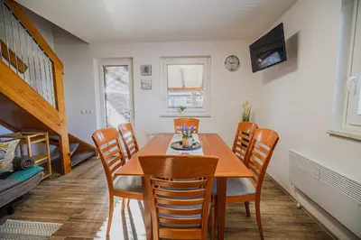 a dining room with a wooden table and chairs at Holiday Home Oxi in Čatež ob Savi