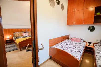 a room with two beds and a door to a bedroom at Holiday Home Oxi in Čatež ob Savi