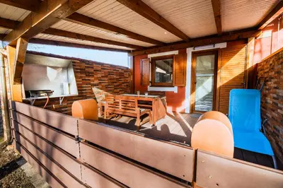 a patio with a table and chairs on a building at Holiday Home Oxi in Čatež ob Savi