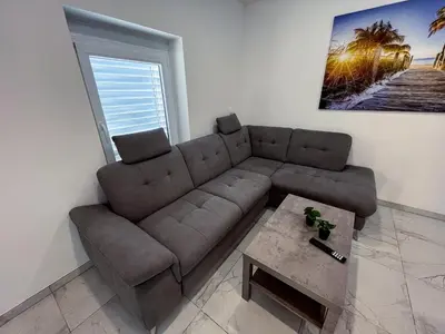 a living room with a couch and a coffee table at Apartment Mandy in Rečica ob Savinji