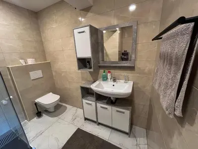 a bathroom with a sink and a toilet at Apartment Mandy in Rečica ob Savinji