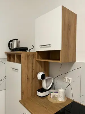 a kitchen with a cupboard and a blender on a counter at Grajski kamen apartment in Maribor