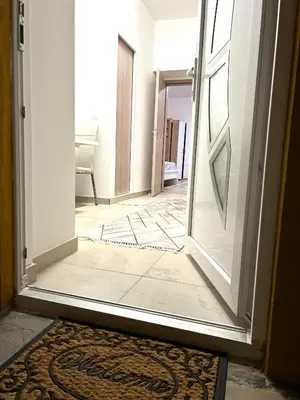 an open door to a room with a rug at Grajski kamen apartment in Maribor