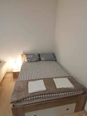 a bed in a room with two towels on it at Grajski kamen apartment in Maribor
