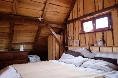 a bedroom with a bed in a wooden room at Wooden love nest in Vransko