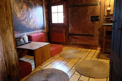 a room with two chairs and a table and two stools at Wooden love nest in Vransko