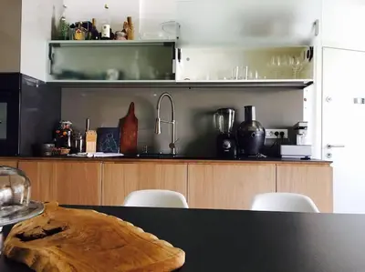 a kitchen with a counter and a table with chairs at Ljubljana City Apartment Metelkova in Ljubljana