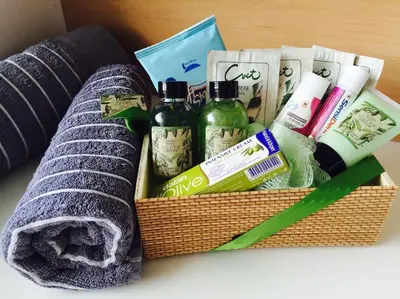 a basket of hygiene products and towels on a table at Ljubljana City Apartment Metelkova in Ljubljana