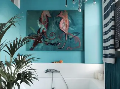 a bathroom with a painting above a bath tub at Ljubljana City Apartment Metelkova in Ljubljana