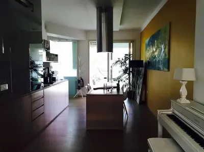 a kitchen with a table and a piano in a room at Ljubljana City Apartment Metelkova in Ljubljana