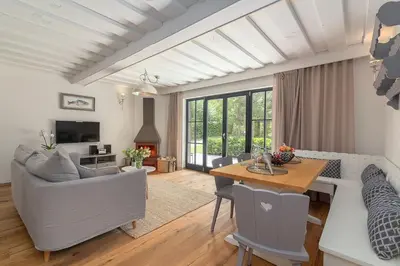 a living room with a table and a couch at Villa Polje in Bohinj