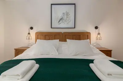 a bedroom with a bed with two white towels on it at Villa Polje in Bohinj