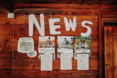 a sign that says news hanging on a wall at DS Camping in Grgar