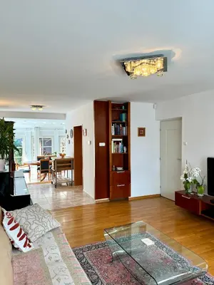 a living room with a couch and a glass table at Central Villa with Garden in Ljubljana