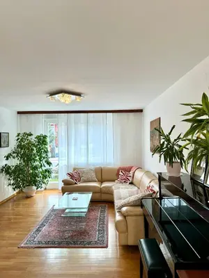 a living room with a couch and a table at Central Villa with Garden in Ljubljana