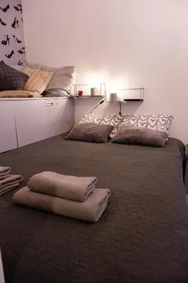 a large bed with pillows on it in a room at Lovely City Nest in Ljubljana
