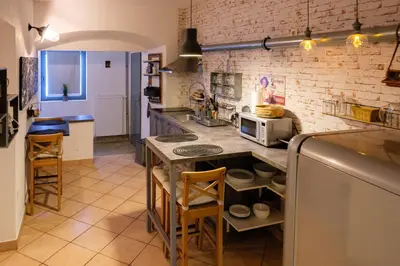a kitchen with a counter with chairs and a counter top at Lovely City Nest in Ljubljana