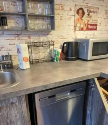 a kitchen counter with a sink and a microwave at Lovely City Nest in Ljubljana