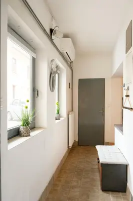 a hallway with a bench and a window at Lovely City Nest in Ljubljana