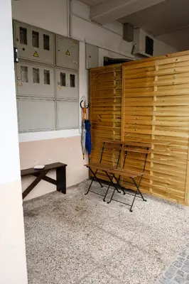 a room with a bench and a wooden wall at Lovely City Nest in Ljubljana