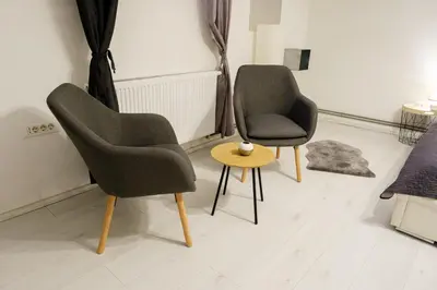 two chairs and a table in a room at Lovely City Nest in Ljubljana
