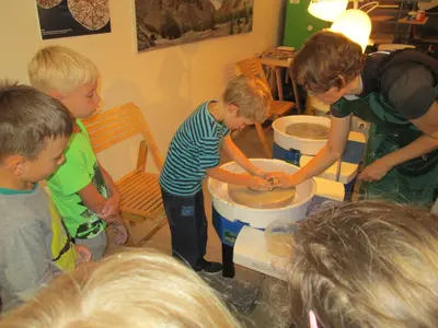 a group of children playing with toilets in a room at Bed & Breakfast Base Camp in Križe