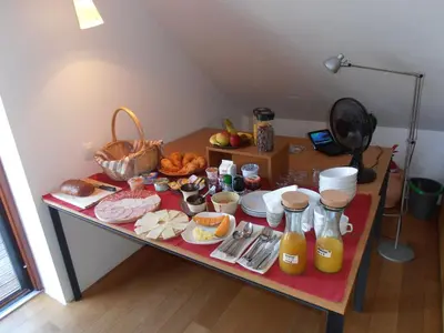 a table with a bunch of food on it at Bed & Breakfast Base Camp in Križe
