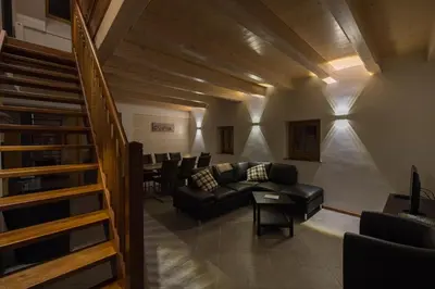 a living room with a couch and a table at Holiday Home Planina in Tržič