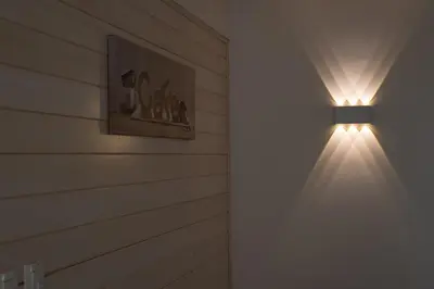 a light on a wall in a room at Holiday Home Planina in Tržič