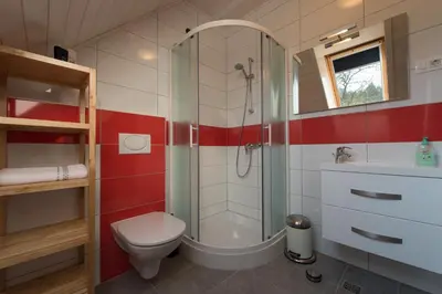 a bathroom with a shower and a toilet and a sink at Holiday Home Planina in Tržič