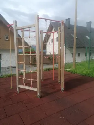 a playground with a ladder and a monkey bar at Holiday Home Planina in Tržič