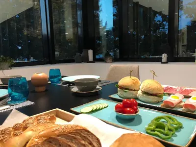 a table with a tray of sandwiches and bread at Hotel Cubis in Lendava
