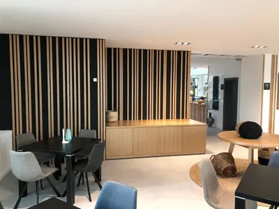 a living room with a black table and chairs at Hotel Cubis in Lendava