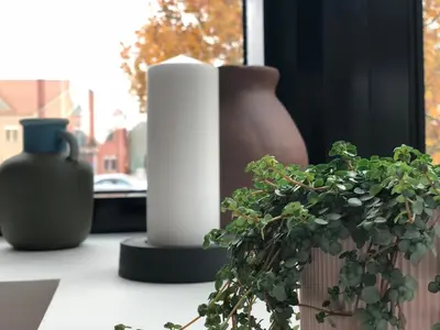 a group of vases and a plant on a window sill at Hotel Cubis in Lendava