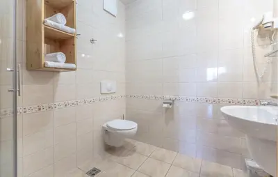 a white bathroom with a toilet and a sink at 2 Bedroom Awesome Apartment In Pohorje in Pohorje