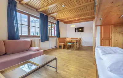 a living room with a couch and a table at 2 Bedroom Awesome Apartment In Pohorje in Pohorje