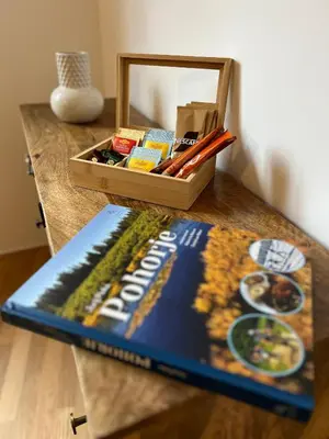 a book sitting on a table next to a box of food at Foxi apartment, Pohorje in Pohorje