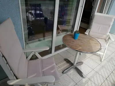 a table and two chairs and a table and a table and chairs at Apartment Lent in Maribor