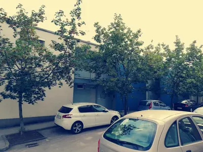 three cars parked in a parking lot next to a building at Apartment Lent in Maribor